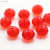 A collection of bright red, round crystal glass beads for jewelry making.