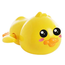 A bright yellow wind-up swimming duck bath toy for toddlers with large black eyes and an orange beak.