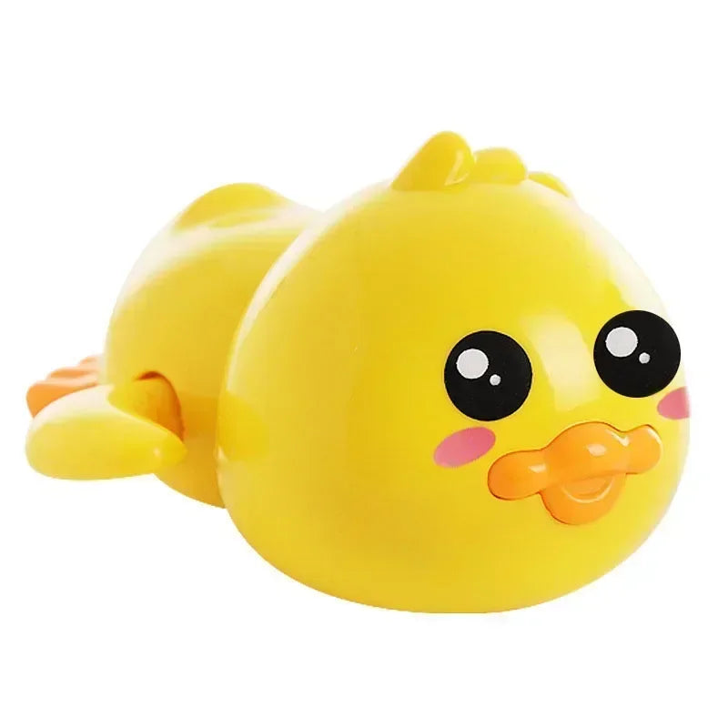 A bright yellow wind-up swimming duck bath toy for toddlers with large black eyes and an orange beak.