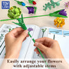 Hands arrange colorful flowers with adjustable stems from a building block set.