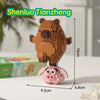 A brown Shenlu Tianzheng bear figure standing on a pink capybara building block base.