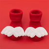 Pair of red baby anti-slip cotton socks with white festive Christmas wing designs