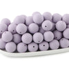 A pile of round, light purple silicone beads for jewelry making and DIY crafts.