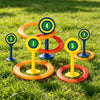 A set of five colored rings and stakes for a classic ring toss game placed on green grass.