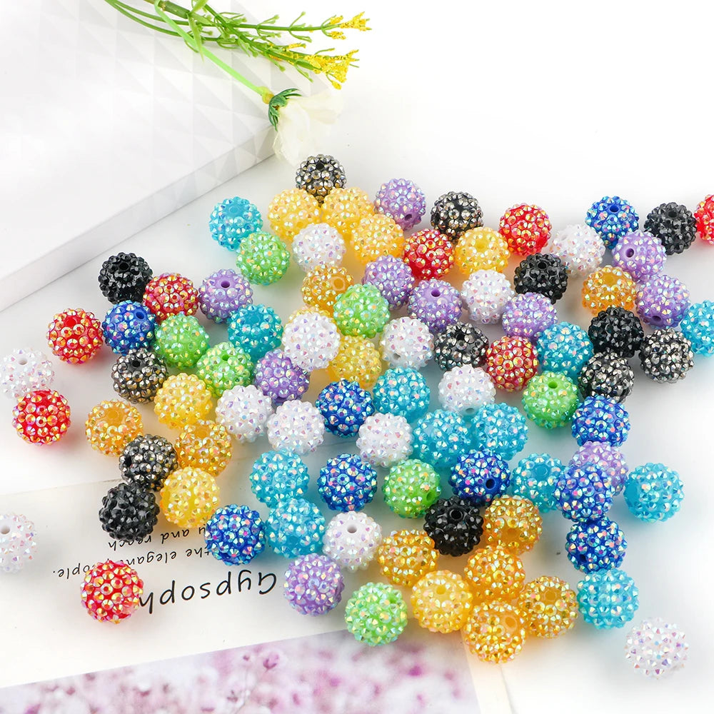 A collection of colorful rhinestone acrylic beads in various shades and sizes for jewelry making