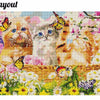 A diamond painting depicting a vibrant floral landscape with fluffy orange and white cats amidst pink blossoms.