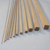 A collection of natural solid wood strips of varying lengths and widths laid diagonally on a white surface.