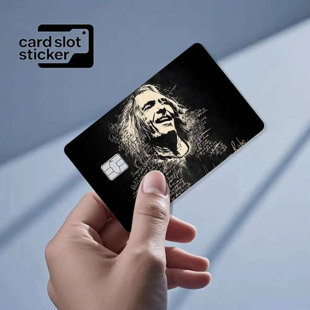 A hand holds a black card slot sticker featuring a grayscale portrait of Jimi Hendrix.