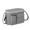 A gray stroller organizer bag with a bottle holder and carrying straps.
