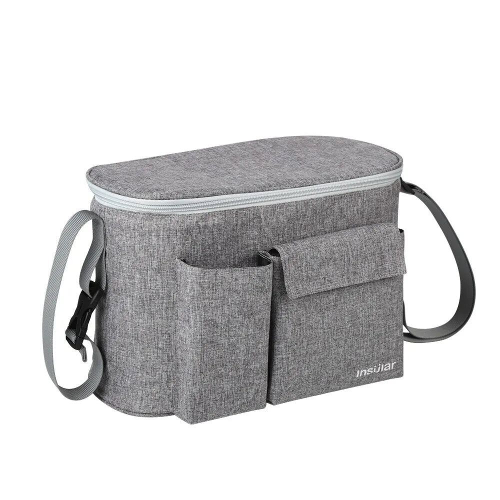 A gray stroller organizer bag with a bottle holder and carrying straps.