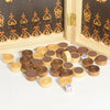 A set of wooden chess and checkers pieces arranged on a white surface next to a decorative wooden frame.