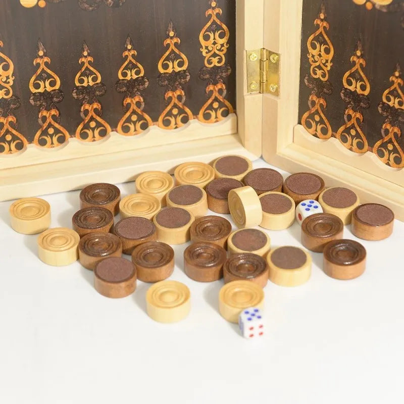 A set of wooden chess and checkers pieces arranged on a white surface next to a decorative wooden frame.