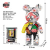 A small bear figure made of micro building blocks, featuring pink and white colors.