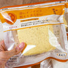 A yellow squishy stress relief toy shaped like toast is shown in a clear plastic bag.