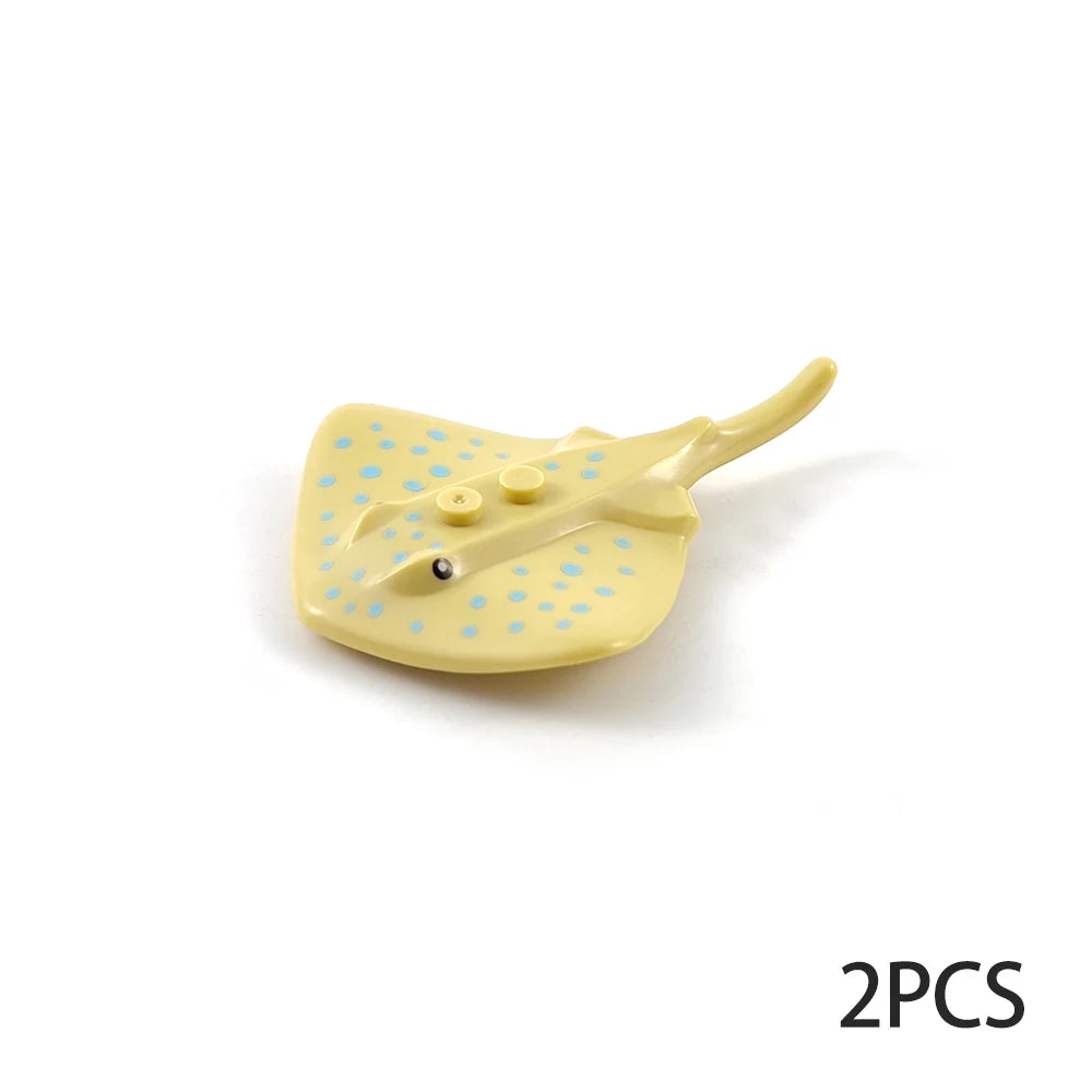 A yellow plastic ocean animal building block with a textured surface and small blue dots.