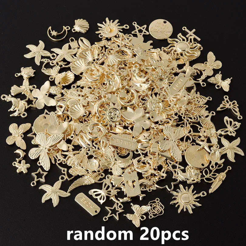 A pile of random gold-colored metal charms for DIY jewelry making