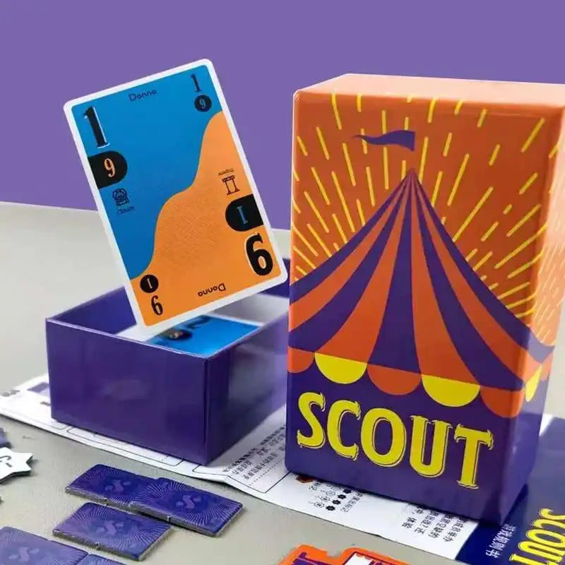 A box of the Scout card game featuring a colorful tent design and a blue card inside.