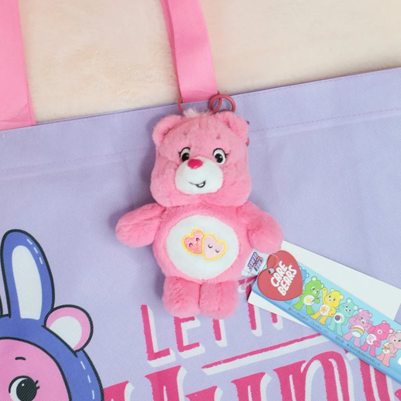 A pink Care Bears plush keychain charm attached to a purple shopping bag.