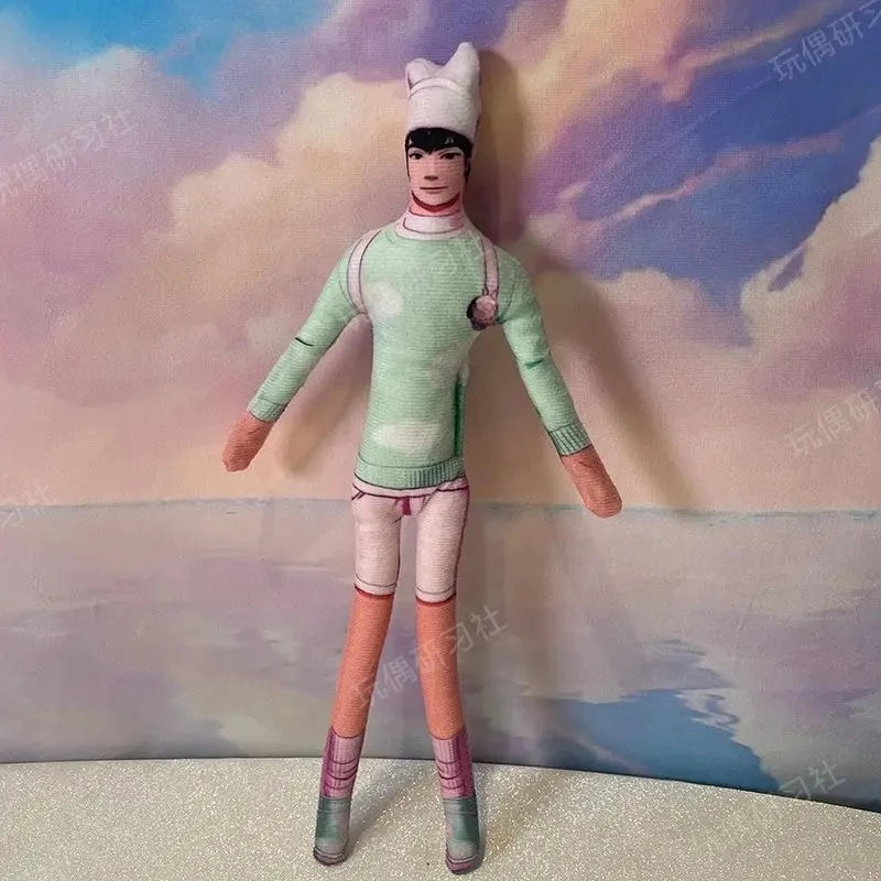 A poseable plush doll figure dressed in a light green outfit and white cap, standing against a cloudy background.
