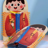 A wooden multi-layer busy board for toddlers featuring a smiling face and layered fabric items.