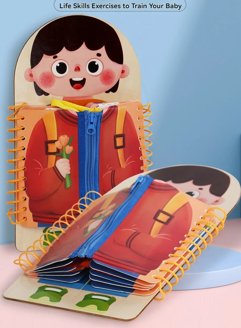 A wooden multi-layer busy board for toddlers featuring a smiling face and layered fabric items.