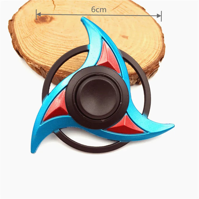A metal fidget spinner with a rainbow finish, featuring blue and red accents.