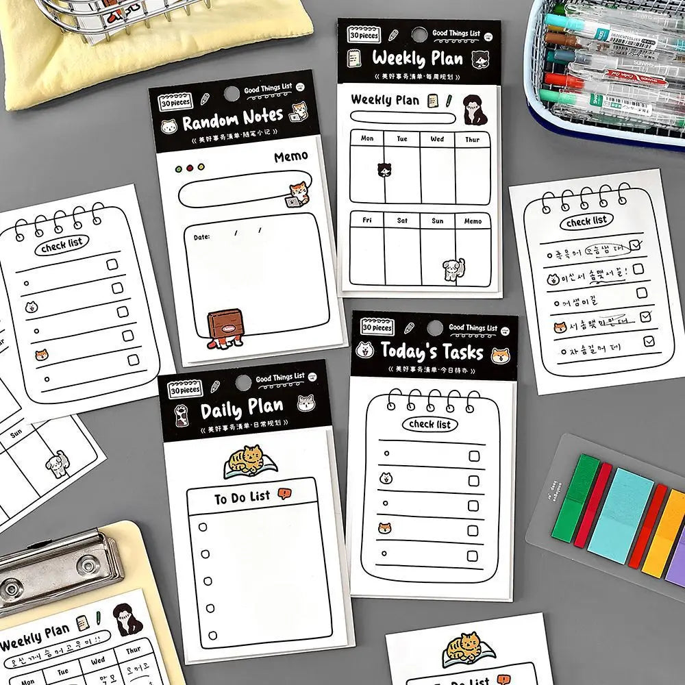 A collection of cute stationery memo pads and weekly planning sheets for daily organization and notes.