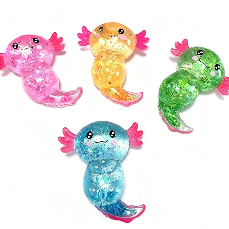 Four colorful glitter axolotl squishy toys in pink, yellow, green, and blue.