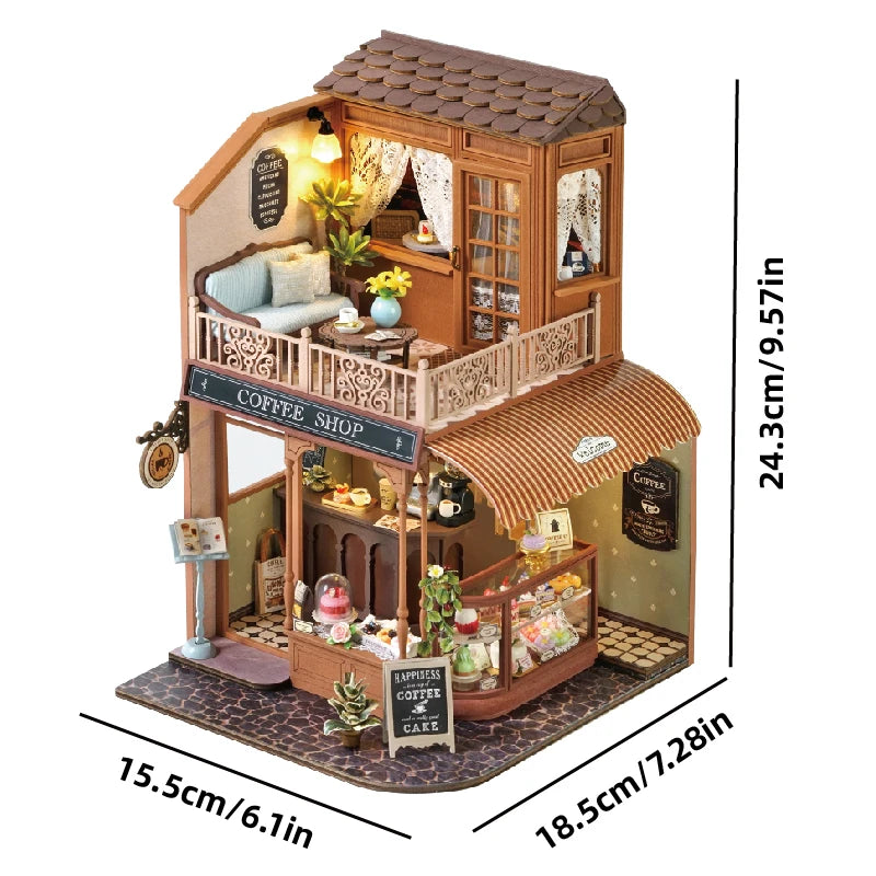 A detailed miniature dollhouse kit featuring a coffee shop facade with furniture and warm lighting.