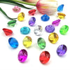 A collection of sparkling acrylic gemstones in various colors including pink, green, yellow, and blue.