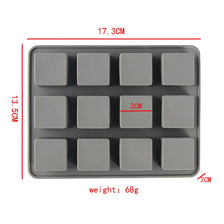 A gray silicone soap mold with 12 square cavities, showing its dimensions and weight.