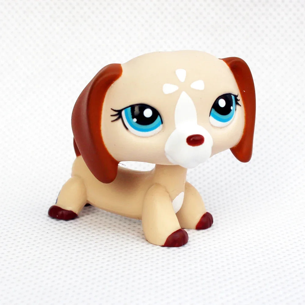 A cute figurine of a dachshund puppy with brown and white markings and bright blue eyes.
