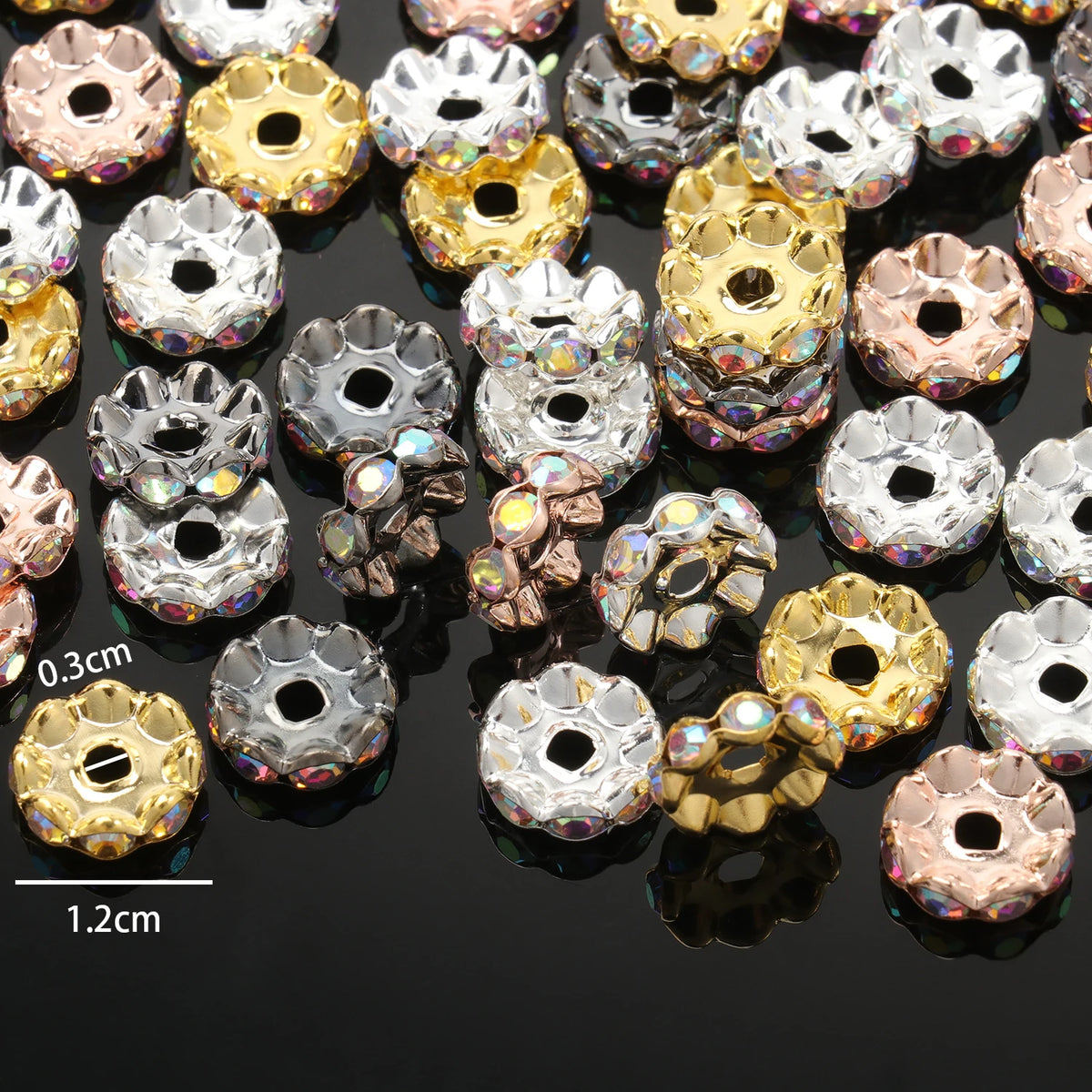 A close-up view of various 12mm crystal rhinestone spacer beads in gold and rose gold tones.