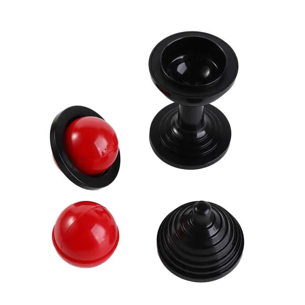 A set of black and red magic props including a black cup and a red ball.