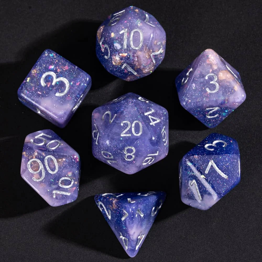 A collection of nine glitter resin polyhedral dice showing various numbers and colors against a dark background.