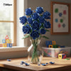 A bouquet of blue roses made from 585 building blocks displayed in a clear glass vase on a wooden table.