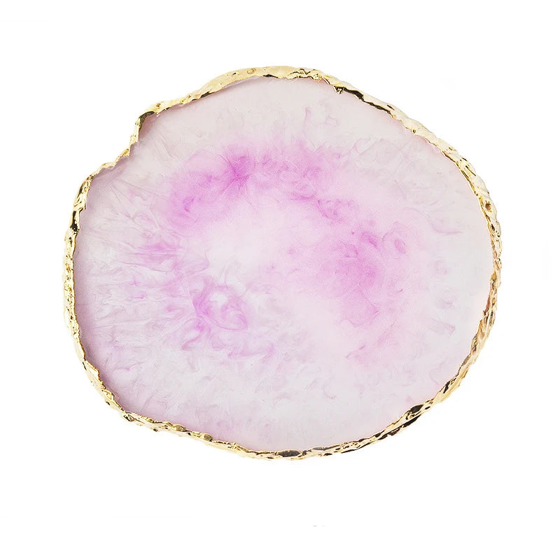 A round, translucent pink resin palette with a gold trim.