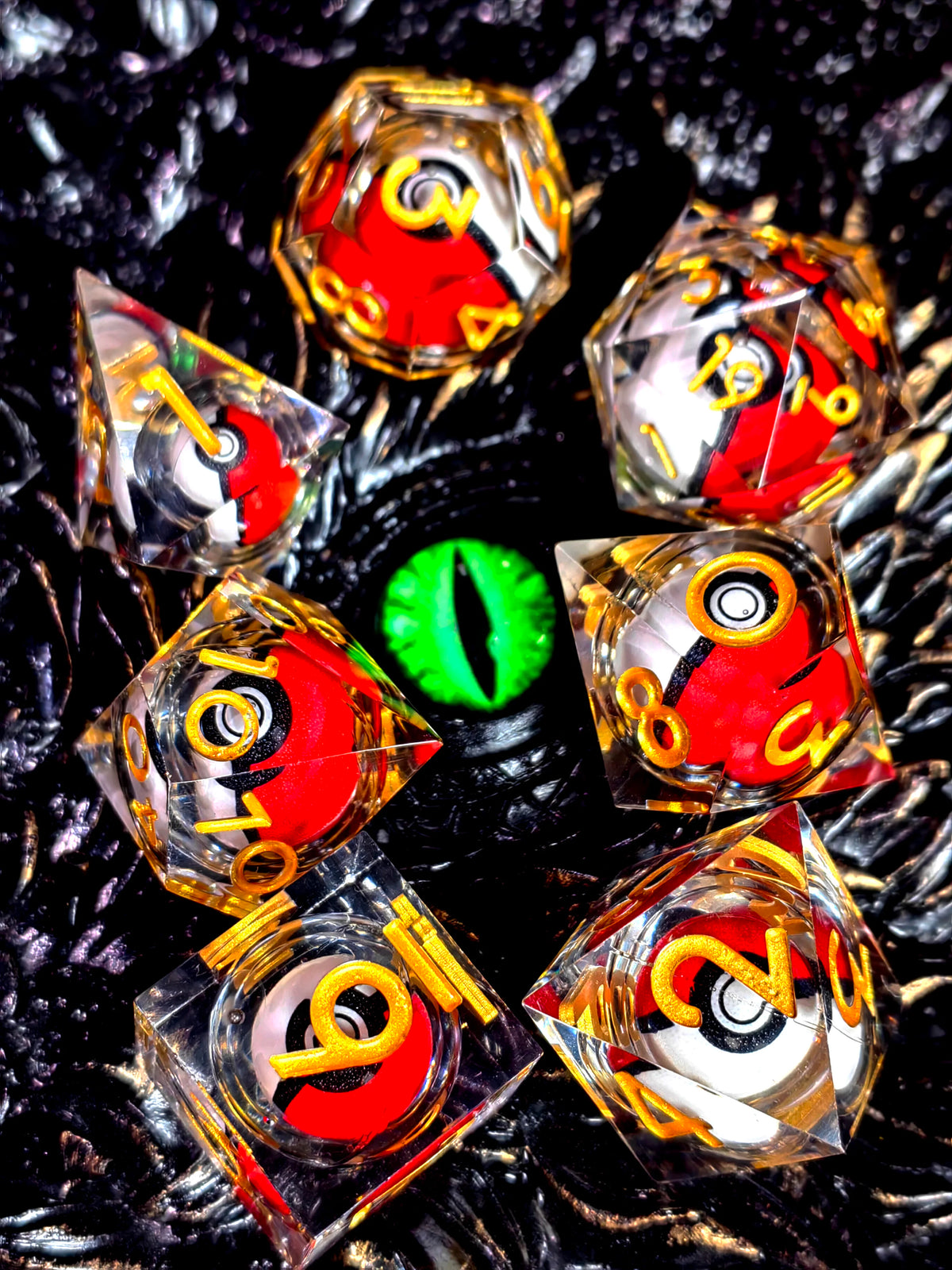 A collection of resin dice featuring a spinning dragon eye core, set against a dark, textured background.