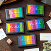 A collection of six rectangular Let's Color pigment ink pads in a rainbow gradient arrangement for crafting and stamping.