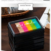 A packaging preview of a set of rainbow gradient ink pads in a black box, displayed on a wooden surface.