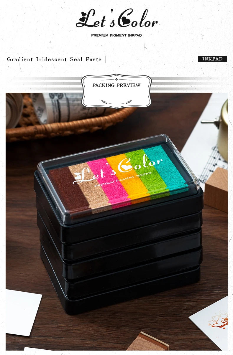 A packaging preview of a set of rainbow gradient ink pads in a black box, displayed on a wooden surface.