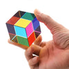A hand holds a CMY Prism Cube, a 3D color mixing crystal with various colored facets.