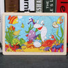 A 24-piece wooden jigsaw puzzle featuring colorful sea animals like a purple fish and a white sea creature.