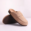 A pair of tan suede cork mules with arch support shown from the side, featuring a brown outsole.