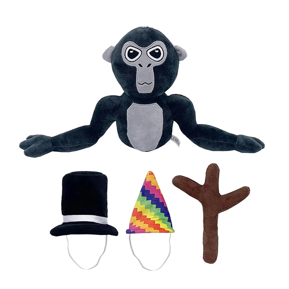 A dark gray and black plush toy of a monkey with large eyes and a small hat and branch accessory.