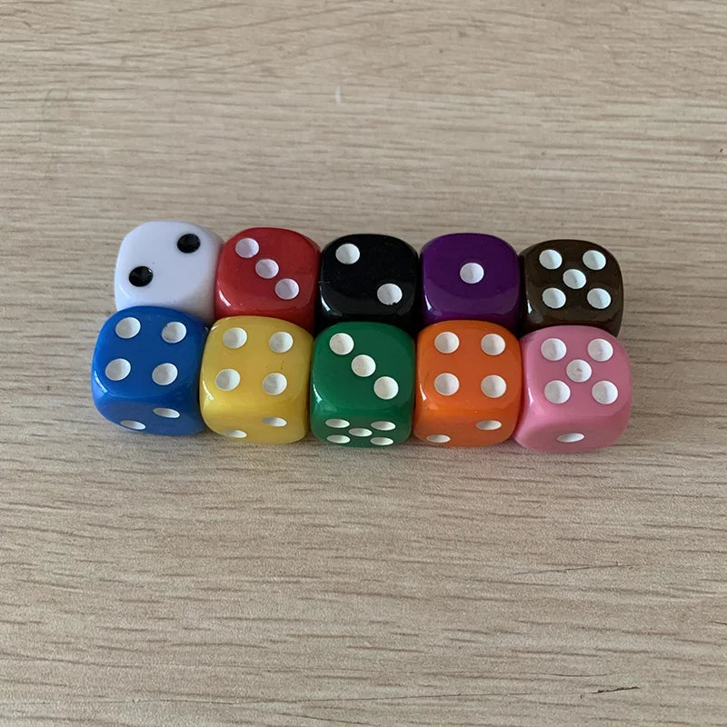 A row of ten colorful solid acrylic dice in various colors like white, red, black, purple, and orange on a wooden surface.