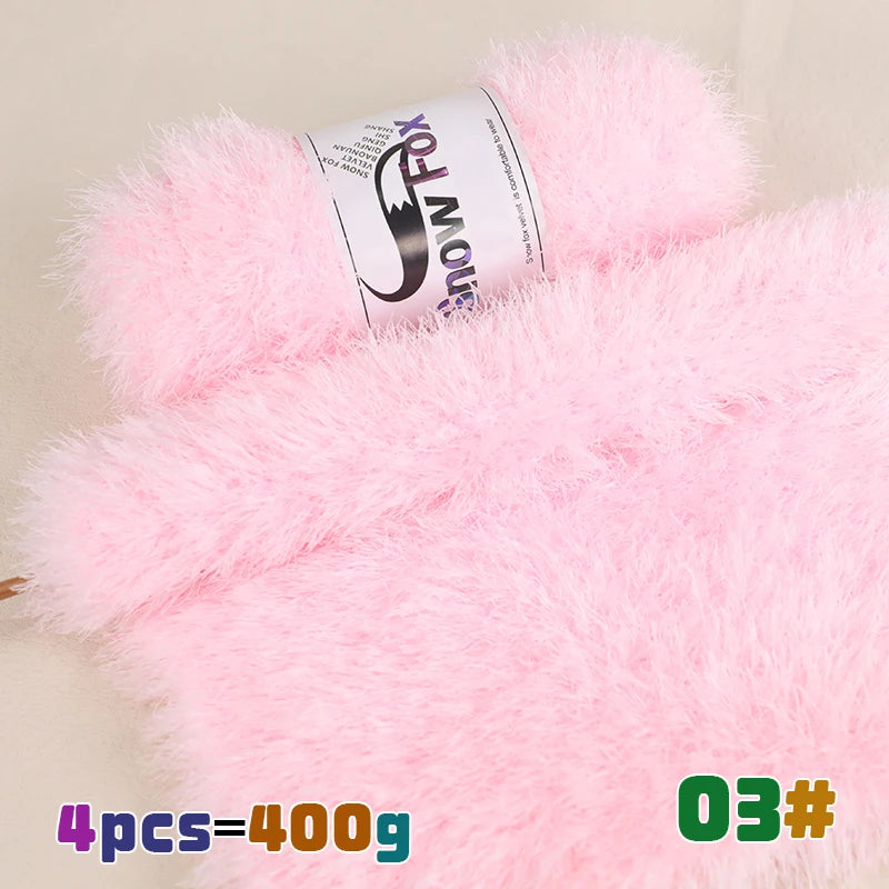 Pink chunky faux fur yarn in a skein with a black and white design