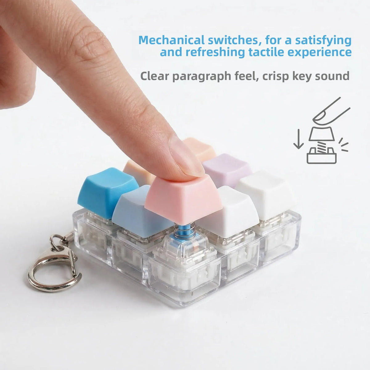 A hand presses colorful mechanical switches on a clear plastic keychain keyboard for a tactile experience.
