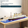 A model of the Titanic iceberg built from micro building blocks displayed on a wooden table.