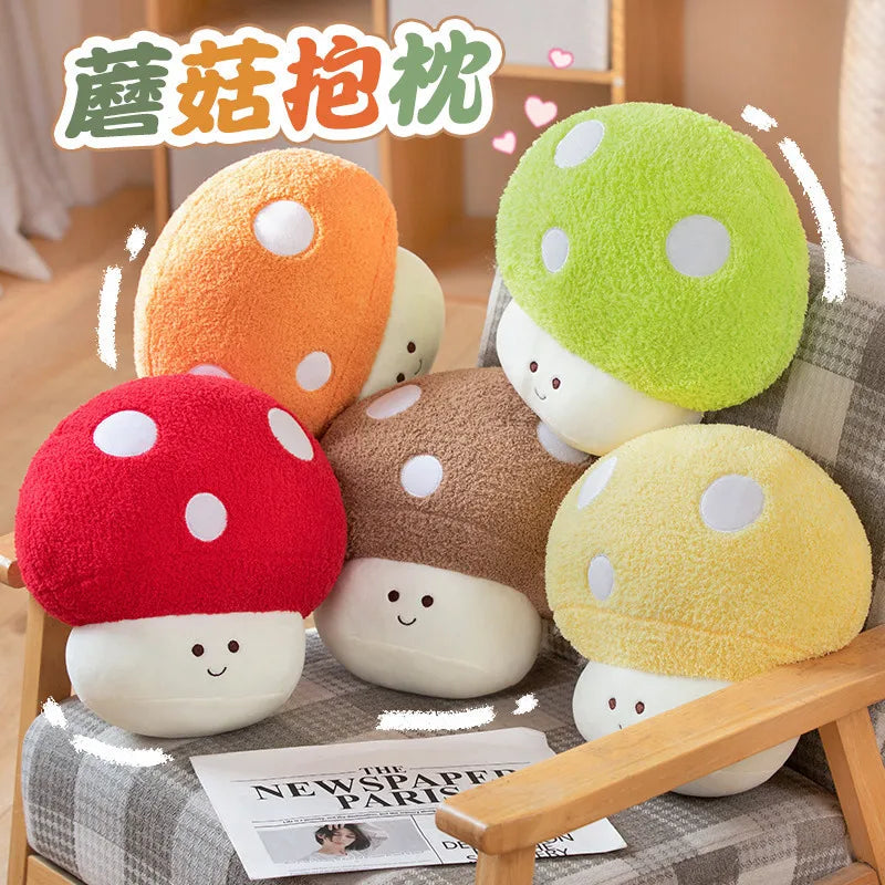 A collection of cute mushroom plush toys in various colors including orange, white, green, and red resting on a gray fabric s